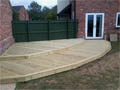 Wooden decking on two levels to create a walkway from the kitchen to the garage