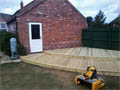 Wooden decking on two levels to create a walkway from the kitchen to the garage